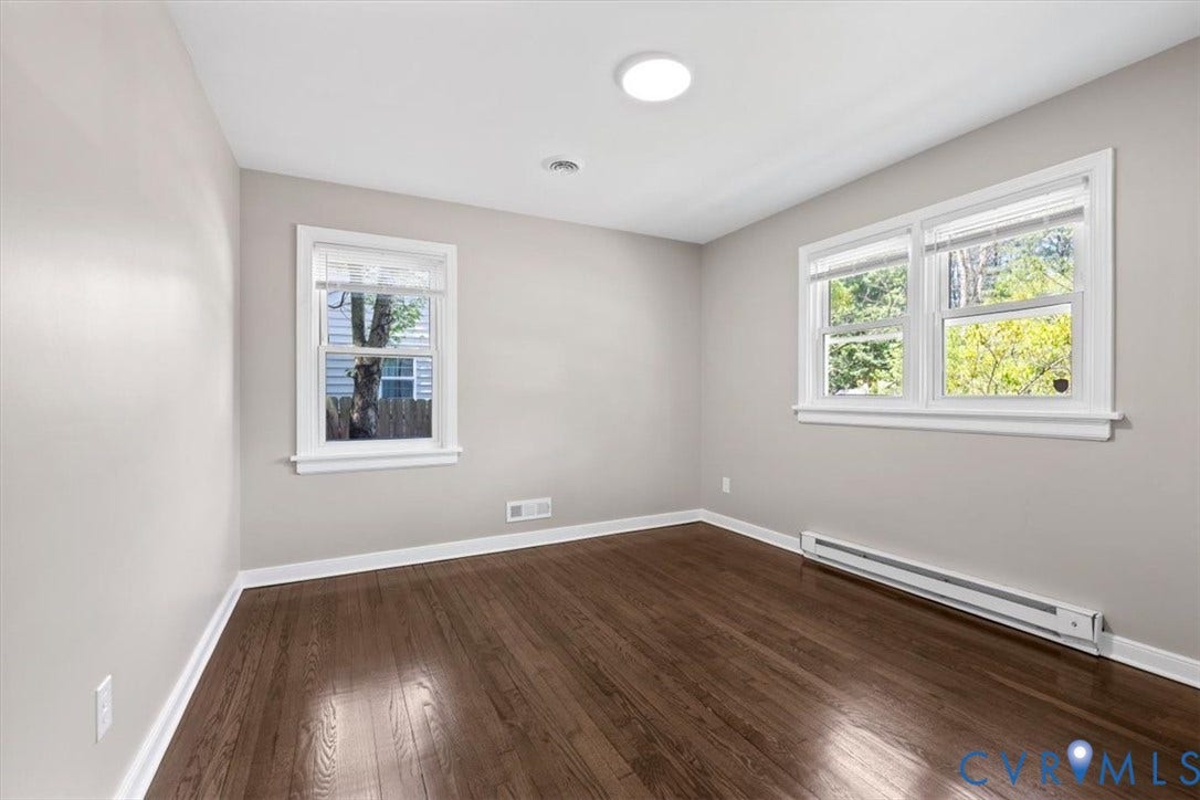 1215 Starling Drive, Henrico, VA 23229 Hardwood-finish flooring, two large windows with white trim, recessed lighting, baseboard heating, and light neutral wall colors