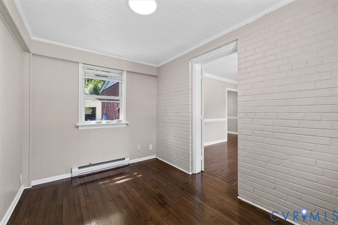 1215 Starling Drive, Henrico, VA 23229 Hardwood flooring, painted brick wall, wood paneling, white trim, and a window with blinds