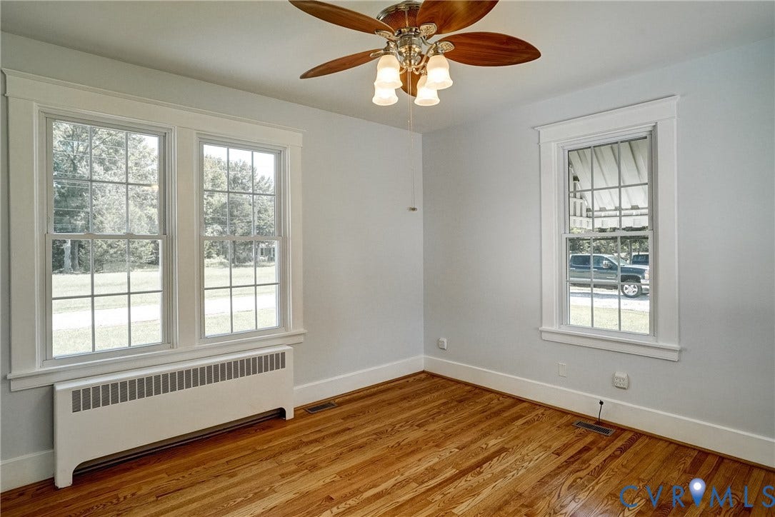 10024 Washington Road, Richmond, VA 23060 Hardwood flooring, painted walls, ceiling fan with integrated lighting, two multi-pane windows, and a baseboard heating unit
