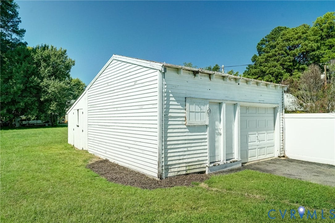 10024 Washington Road, Richmond, VA 23060 Detached structure featuring horizontal siding, a single garage door, an entry door, and an exterior window