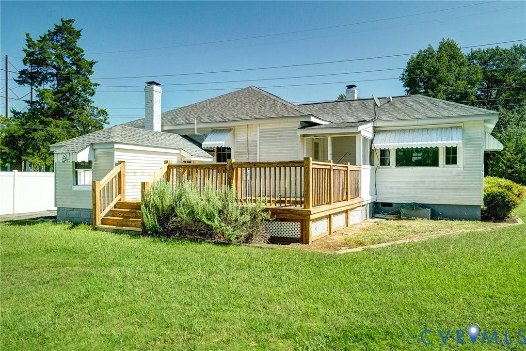10024 Washington Road, Richmond, VA 23060 Wood deck with railings and steps, white siding exterior, fenced perimeter, and a pitched shingle roof