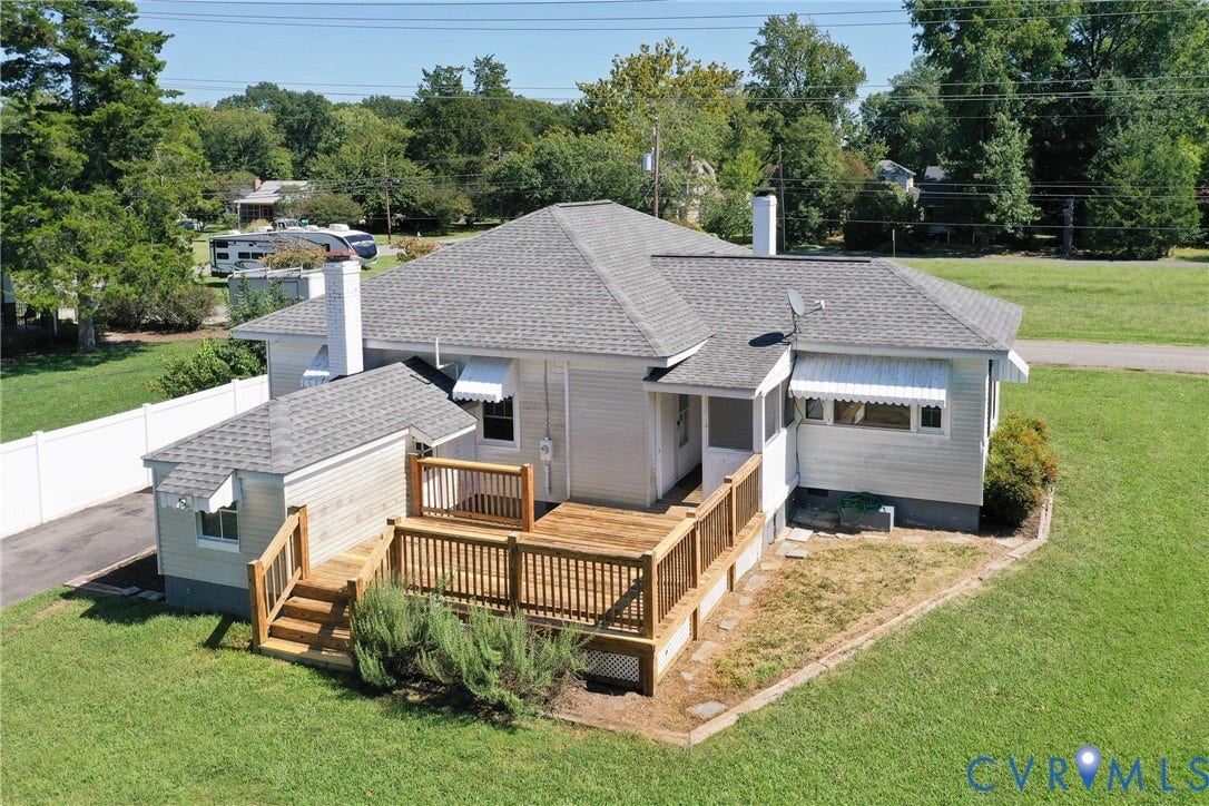 10024 Washington Road, Richmond, VA 23060 Expansive rear deck with wood railing, leading to a separate exterior entrance
