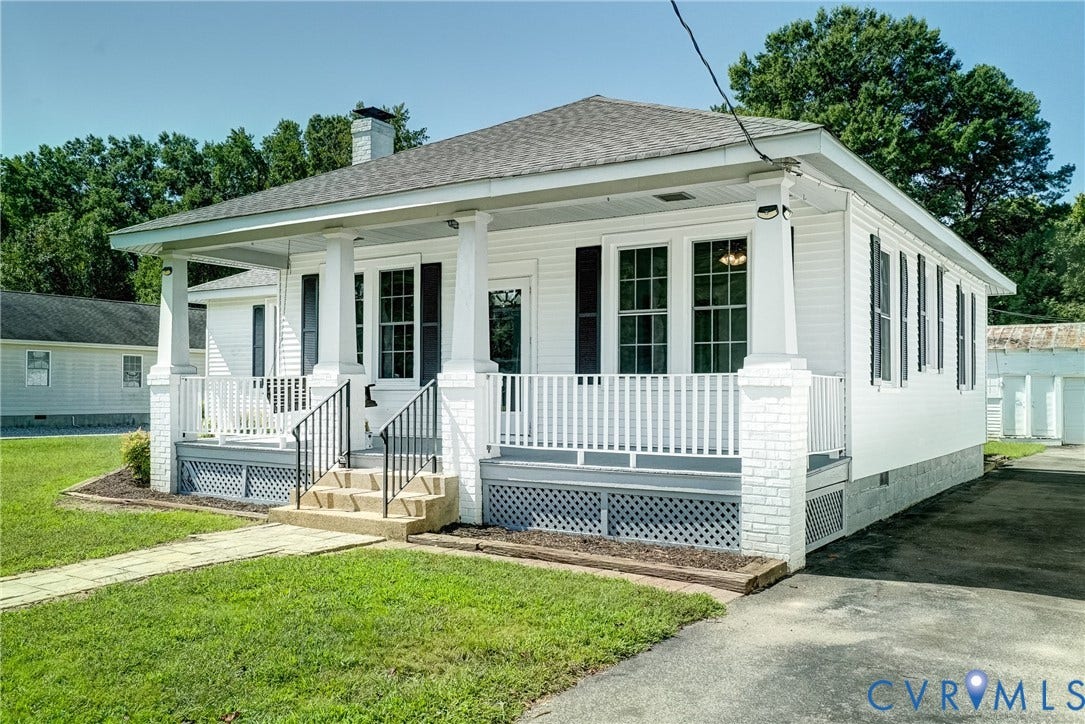 10024 Washington Road, Richmond, VA 23060 White exterior with black shutters and a covered front porch featuring white columns and railing