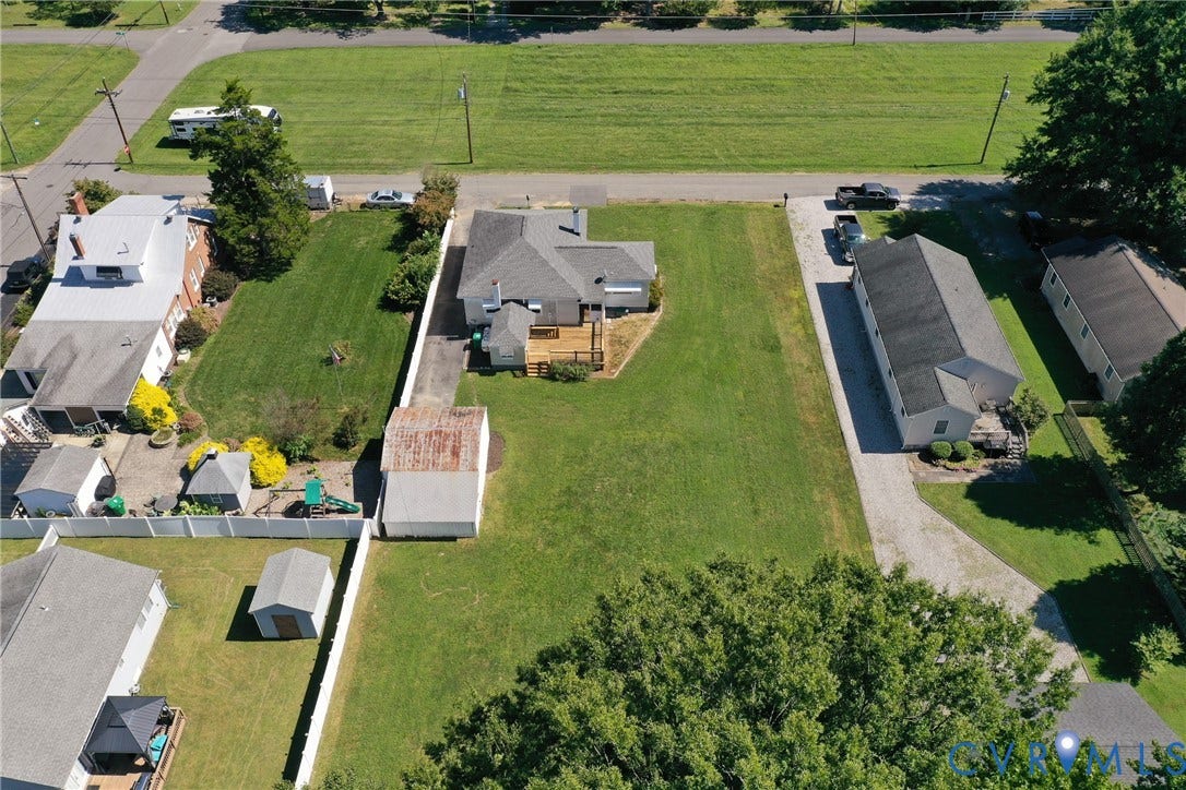 10024 Washington Road, Richmond, VA 23060 Expansive lot featuring a main residence, detached structure, gravel driveway, and mature landscaping
