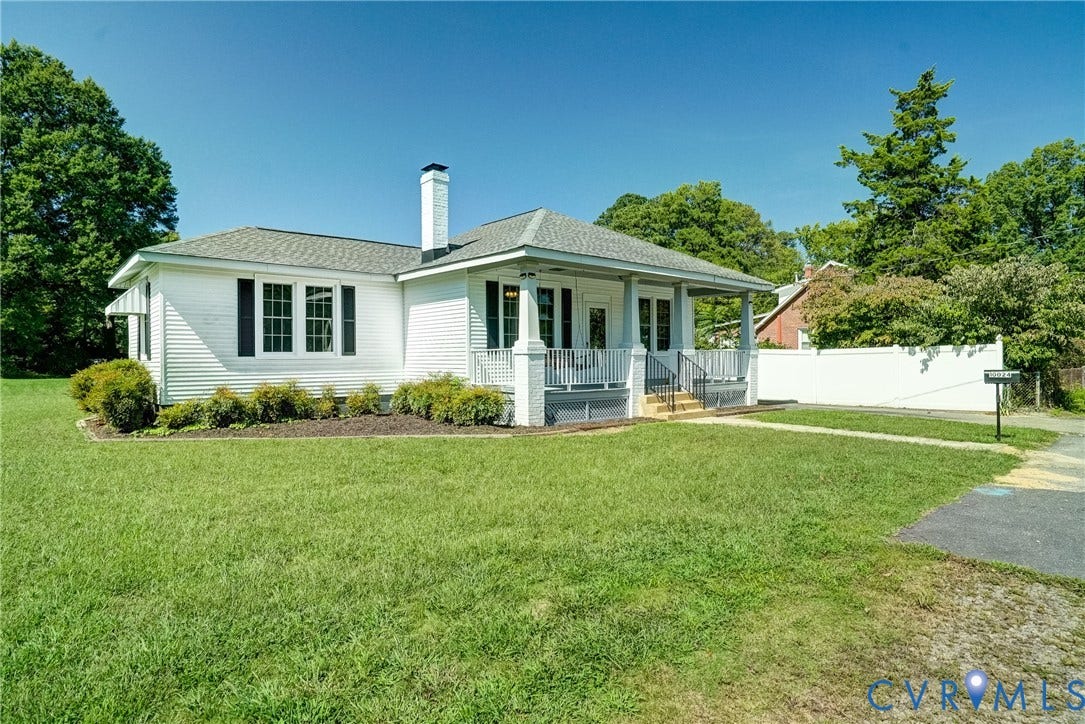 10024 Washington Road, Richmond, VA 23060 White siding exterior with a covered porch, dark gray porch floor, white columns, and a matching white chimney