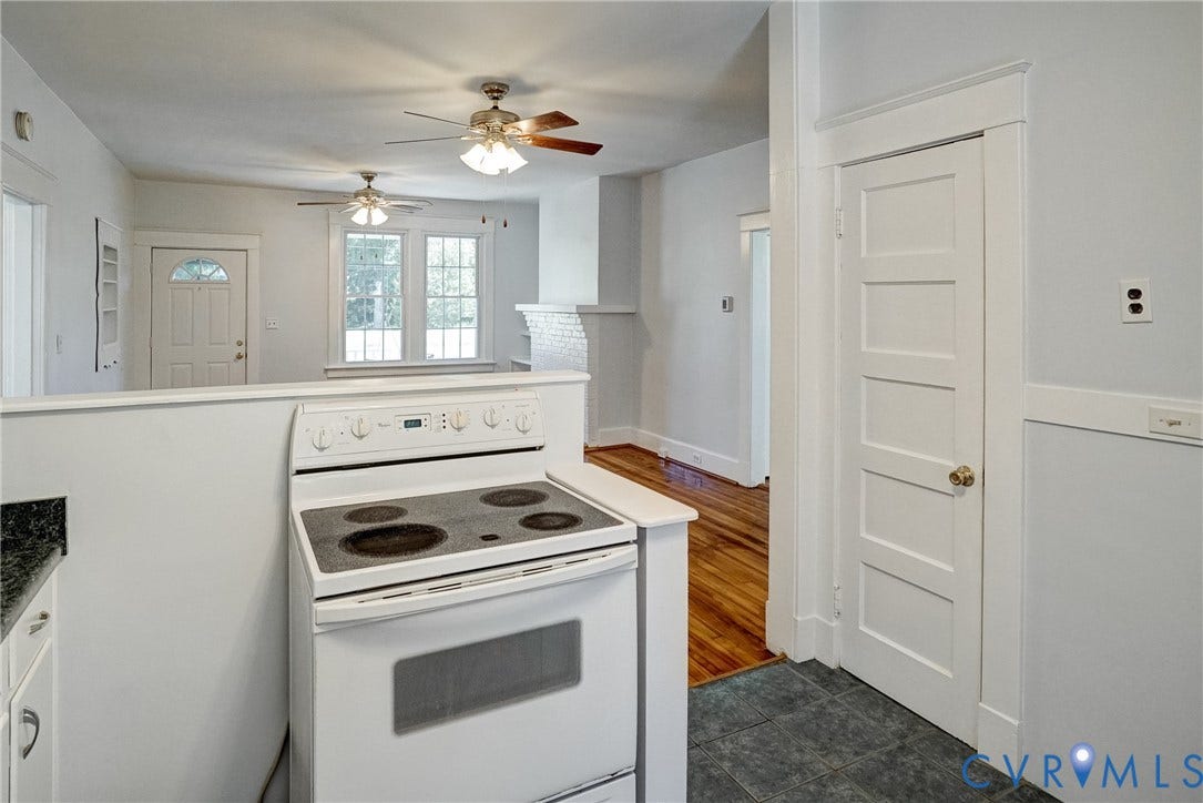10024 Washington Road, Richmond, VA 23060 White electric range with a built-in oven, dark tile flooring, wood-finish flooring, white paneled interior doors, and ceiling fans