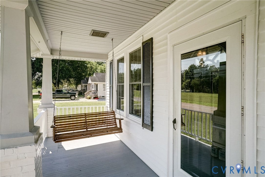 10024 Washington Road, Richmond, VA 23060 Covered porch with white siding, white railing, and a partial brick column base