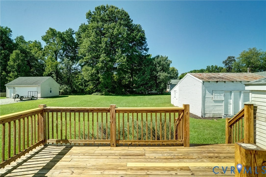 10024 Washington Road, Richmond, VA 23060 Expansive wooden deck with railing, leading to a large grass lawn
