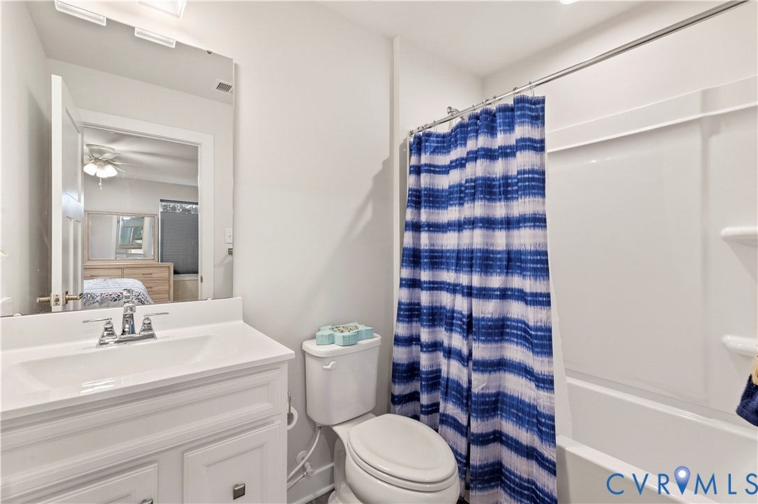4837 Bacova Village Trail, Glen Allen, VA 23059 White vanity with integrated sink, chrome faucet, and rectangular wall mirror