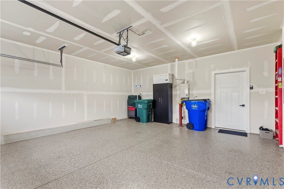 4837 Bacova Village Trail, Glen Allen, VA 23059 Epoxy-coated concrete flooring, overhead garage door opener, interior access door, wall-mounted utility heater, and overhead lighting