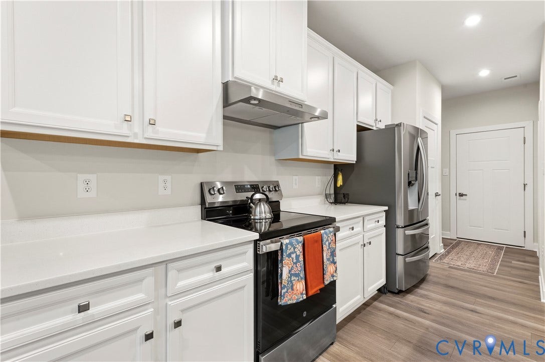 4837 Bacova Village Trail, Glen Allen, VA 23059 White shaker cabinetry, stainless steel appliances, light-toned countertops, and wood-finish flooring
