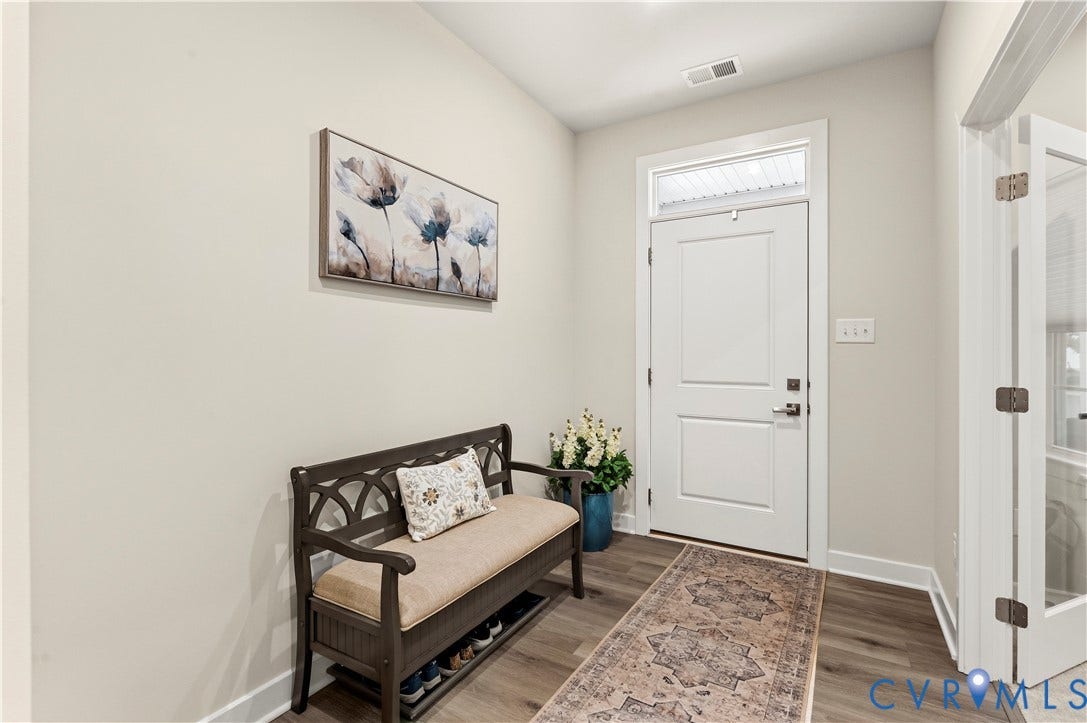 4837 Bacova Village Trail, Glen Allen, VA 23059 Entryway featuring a white paneled door with transom window, wood-finish flooring, and light-colored wall paint
