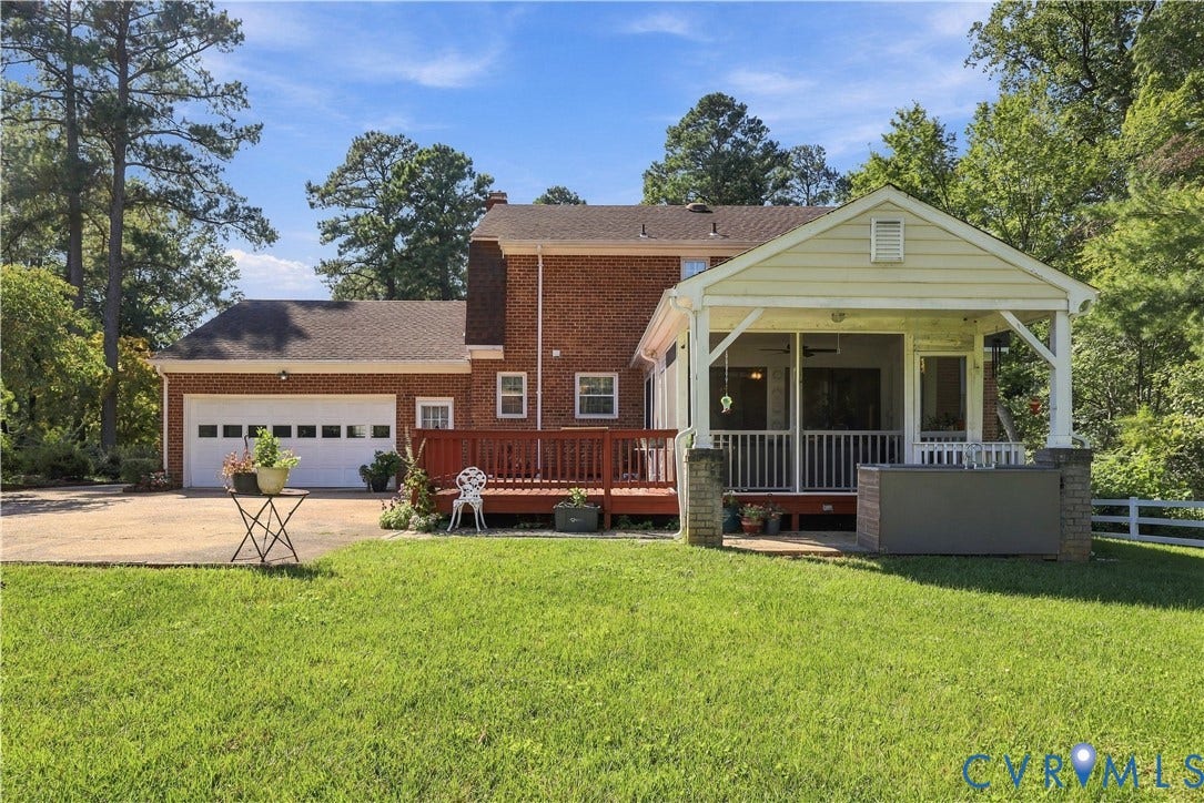8307 Wallingford Lane, Chickahominy Bluffs, Henrico, VA 23227 Brick-clad residence featuring a screened porch, an expansive wood deck, a two-car garage, and a concrete driveway
