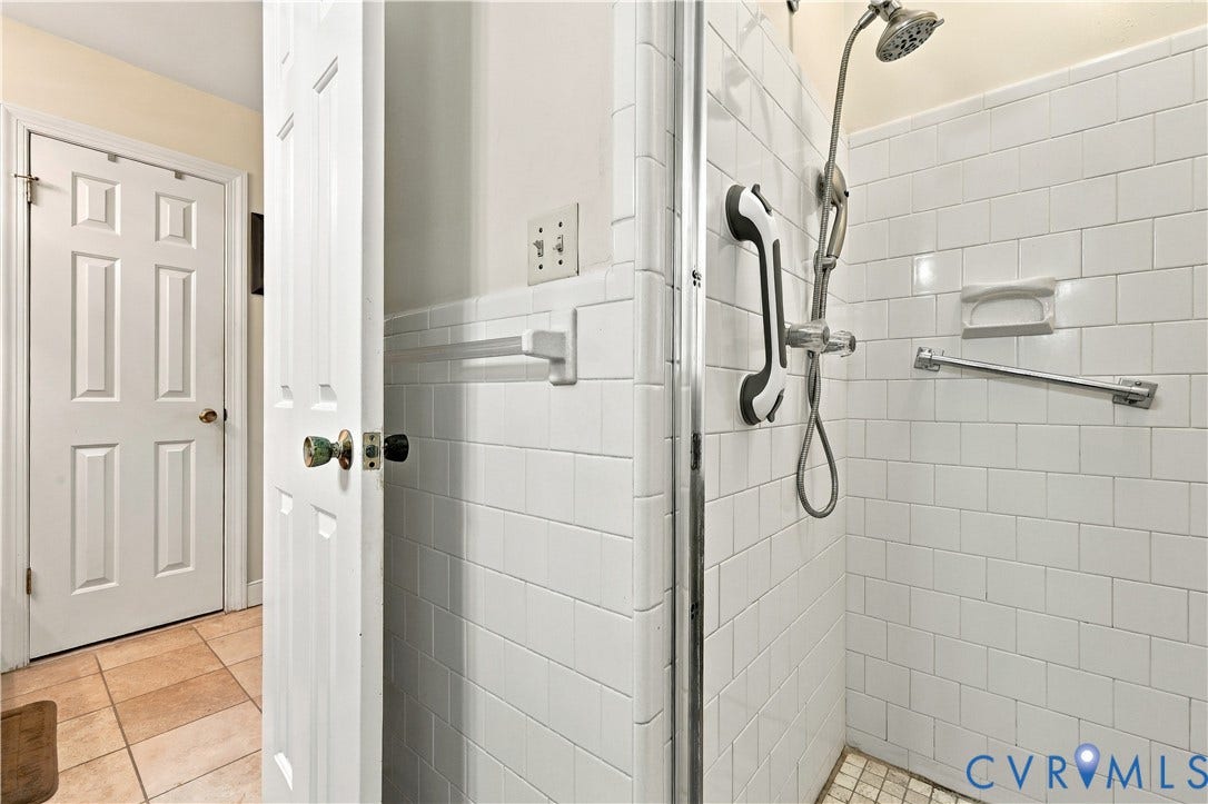 8307 Wallingford Lane, Chickahominy Bluffs, Henrico, VA 23227 Shower enclosure with white subway tile, a chrome handheld shower fixture, and a mosaic tile shower floor