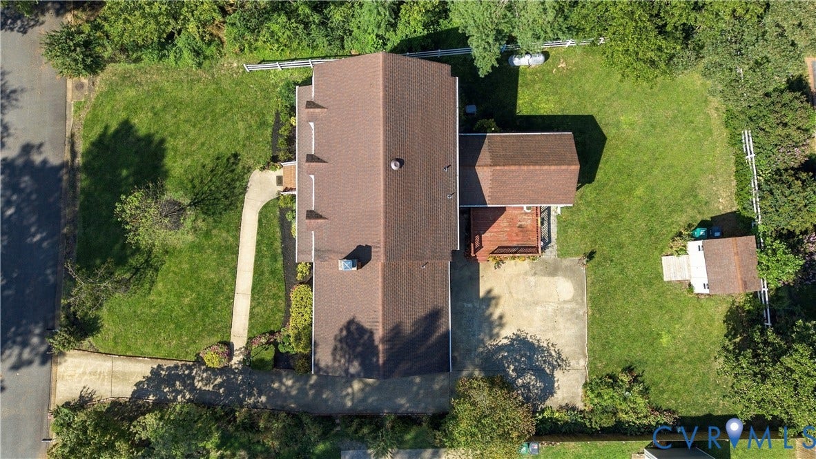 8307 Wallingford Lane, Chickahominy Bluffs, Henrico, VA 23227 Expansive lot featuring a primary residence with a brown roof, an attached deck, a detached shed, and a concrete driveway