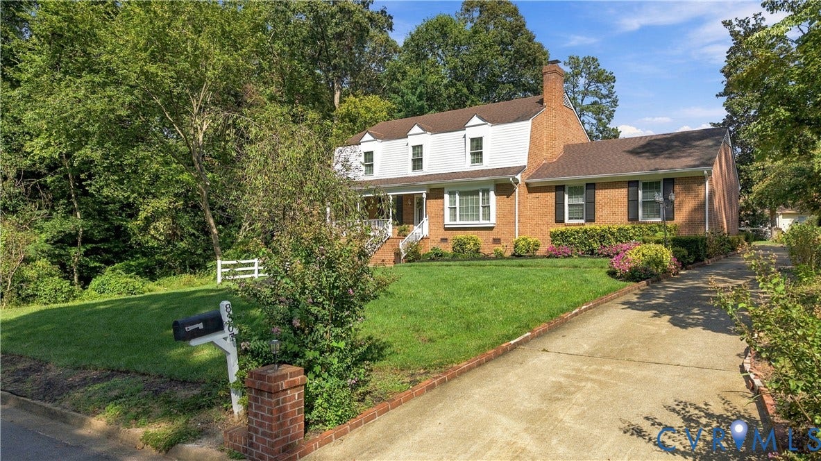 8307 Wallingford Lane, Chickahominy Bluffs, Henrico, VA 23227 Brick exterior featuring white dormer windows, a covered front porch with white railing, and a side driveway