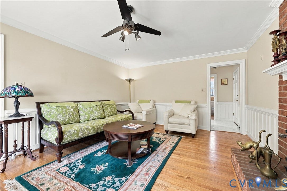 8307 Wallingford Lane, Chickahominy Bluffs, Henrico, VA 23227 Hardwood flooring, brick fireplace with mantel, crown molding, ceiling fan, and wainscoting