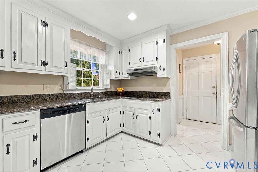 8307 Wallingford Lane, Chickahominy Bluffs, Henrico, VA 23227 White cabinetry with decorative black hardware, dark speckled countertops, stainless steel dishwasher, stainless steel refrigerator, and white tile flooring