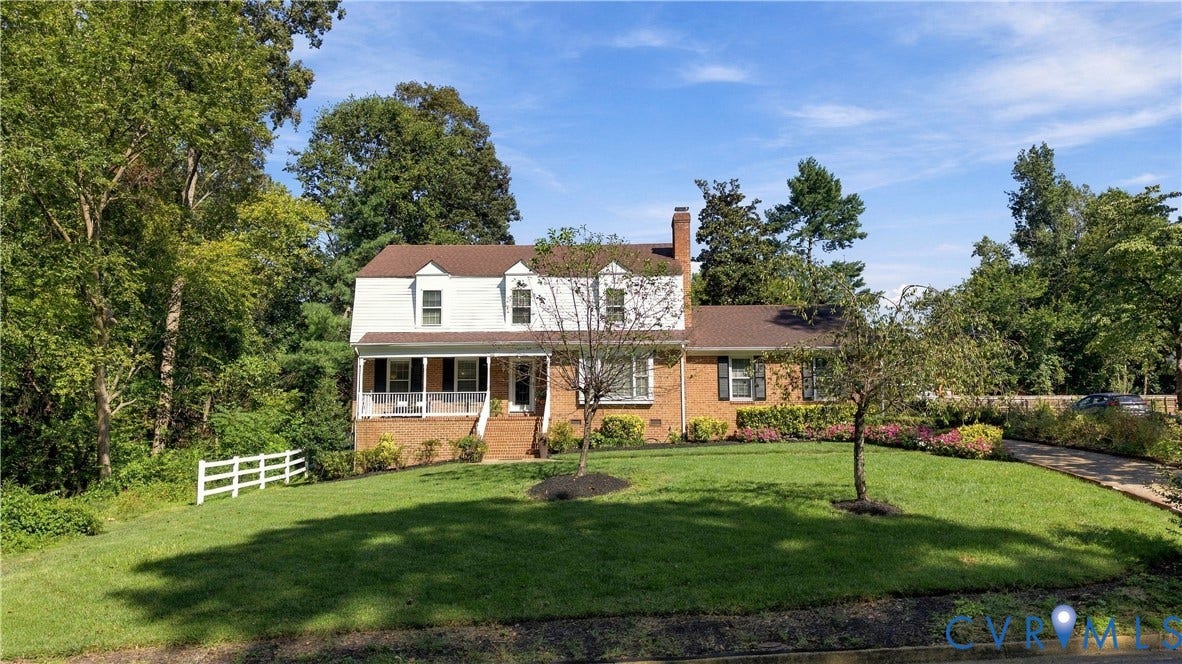 8307 Wallingford Lane, Chickahominy Bluffs, Henrico, VA 23227 Brick and siding exterior, covered front porch, dormer windows, white picket fence, and mature landscaping