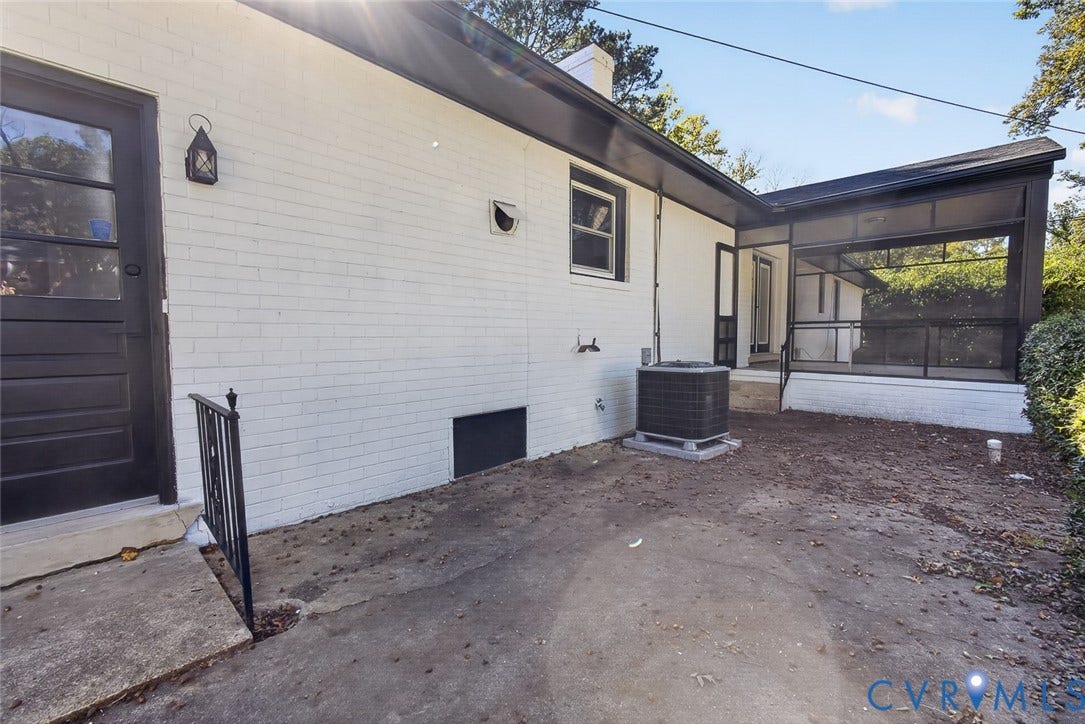 1122 Glidewell Road, Henrico, VA 23227 Painted brick exterior featuring a screened-in porch with metal framing, concrete patio, and exterior wall-mounted lantern-style lighting