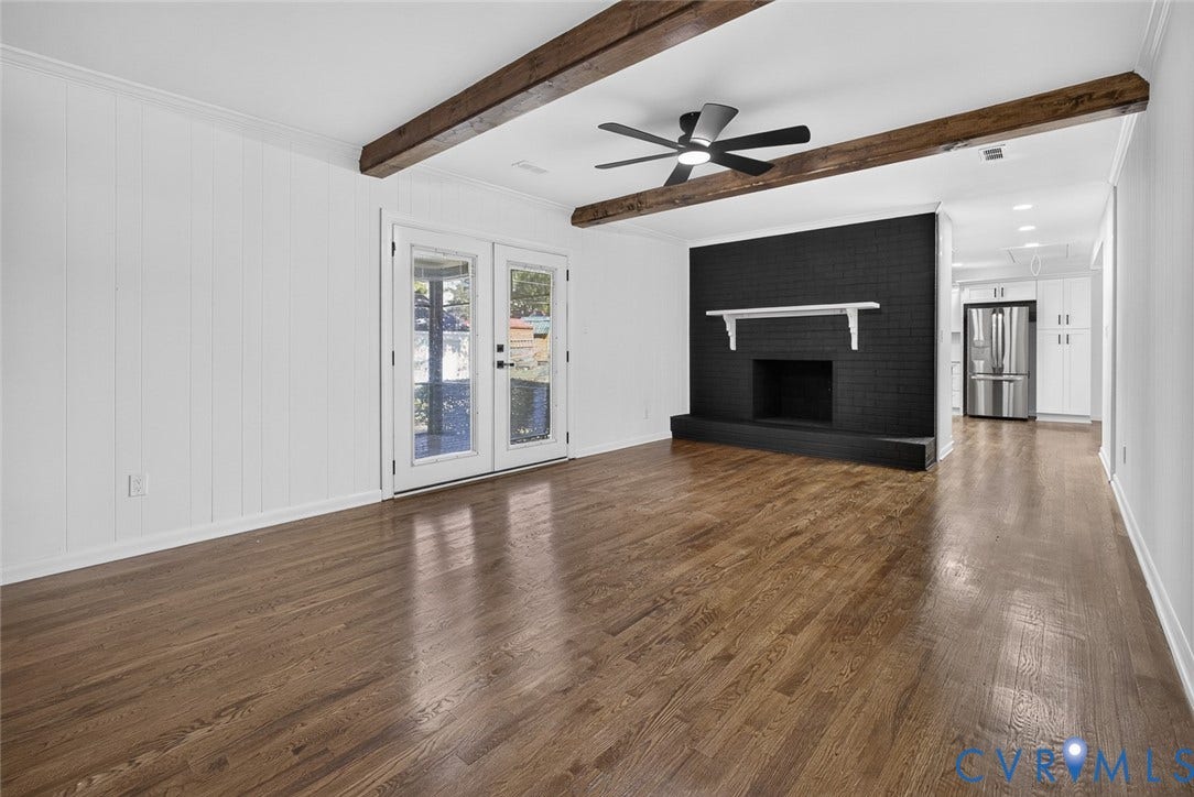 1122 Glidewell Road, Henrico, VA 23227 Interior space featuring wood-finish flooring, exposed ceiling beams, a floor-to-ceiling painted brick fireplace with a mantle, and glass-paned double doors