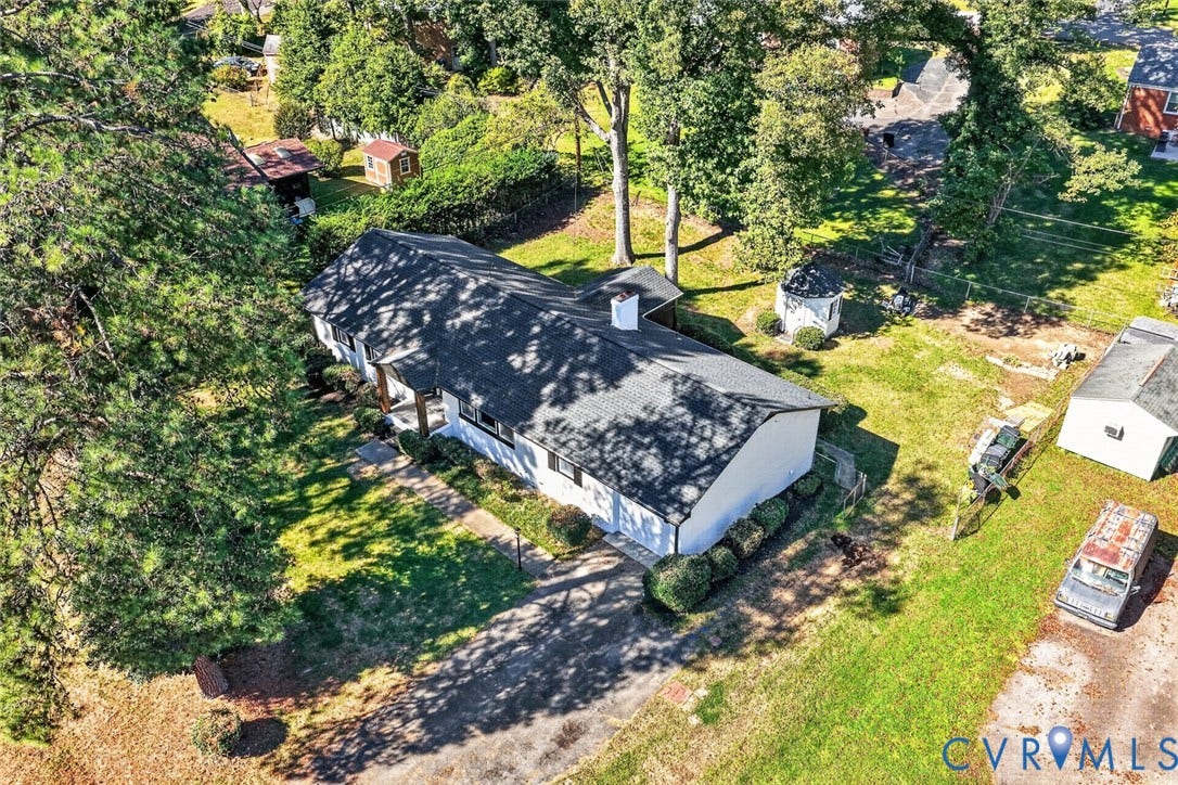 1122 Glidewell Road, Henrico, VA 23227 Aerial perspective of a single-story residence featuring an asphalt shingle roof, a central masonry chimney, an attached garage, a paved driveway, and mature landscaping
