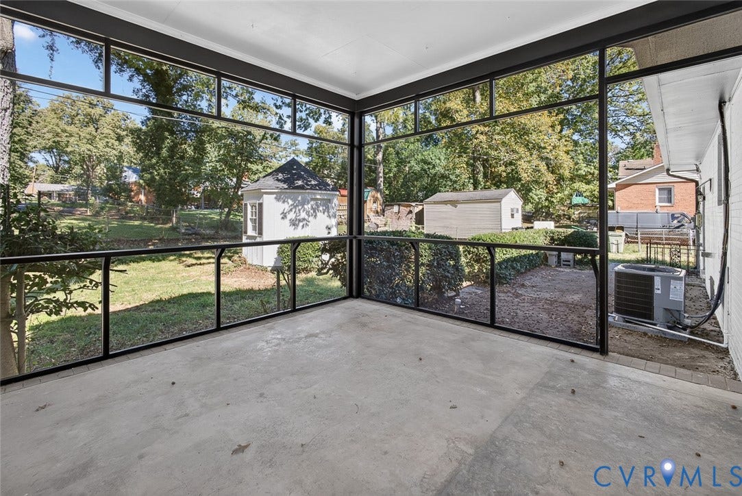 1122 Glidewell Road, Henrico, VA 23227 Screened-in porch featuring full-height glass panels, black metal framing, and concrete flooring