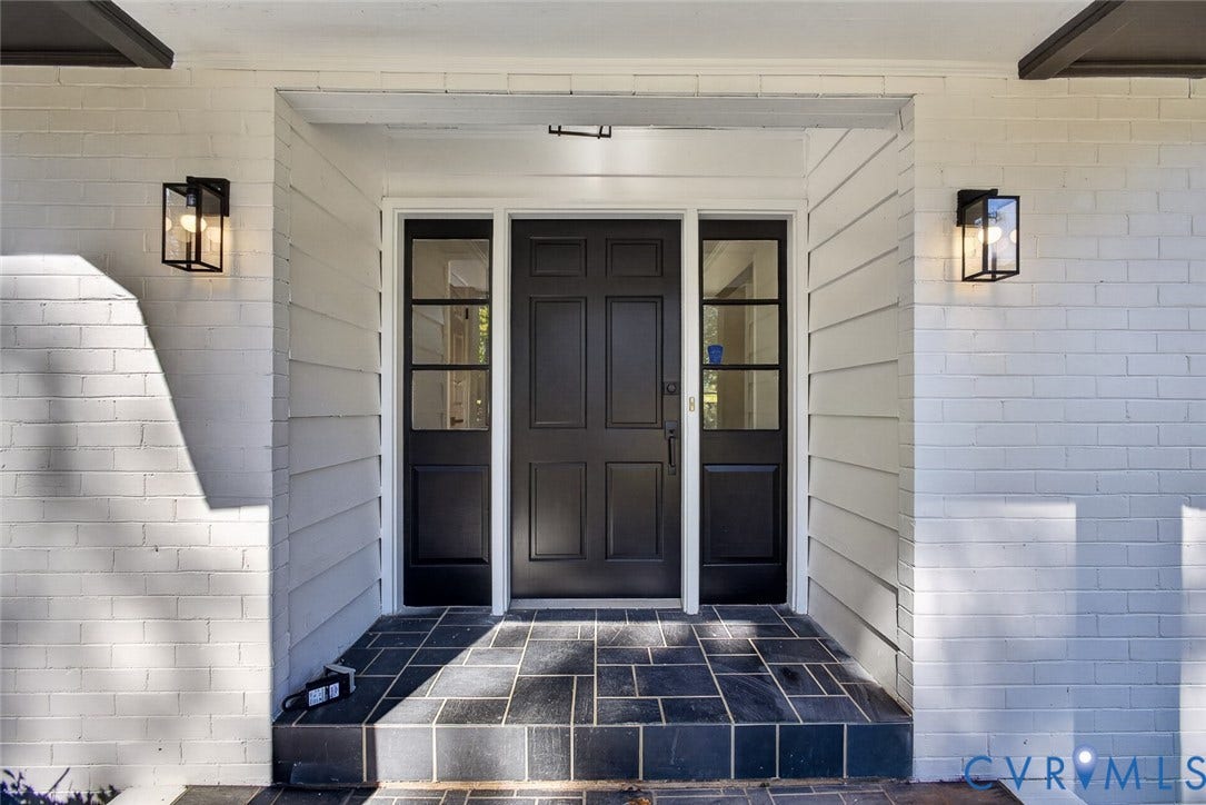 1122 Glidewell Road, Henrico, VA 23227 Entryway featuring painted brick exterior, six-panel dark finish door, flanking glass-paneled sidelights, geometric tile flooring, and rectangular wall-mounted lanterns