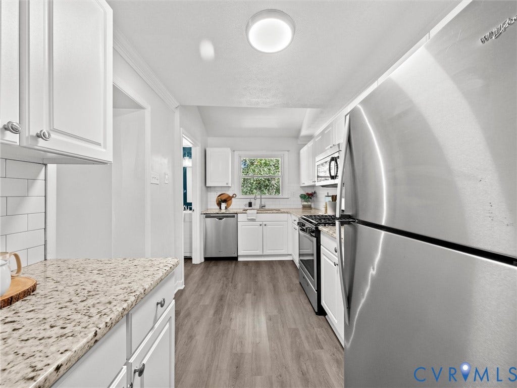 5112 Bethlehem Road, Libbie Mill Area, Richmond, VA 23230 Kitchen featuring white cabinetry, granite-finish countertops, wood-finish flooring, white subway tile backsplash, and stainless steel appliances