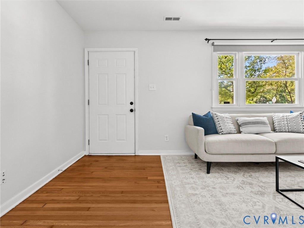 5112 Bethlehem Road, Libbie Mill Area, Richmond, VA 23230 Warm wood-finish flooring, white paneled door, and a large window providing ample natural light