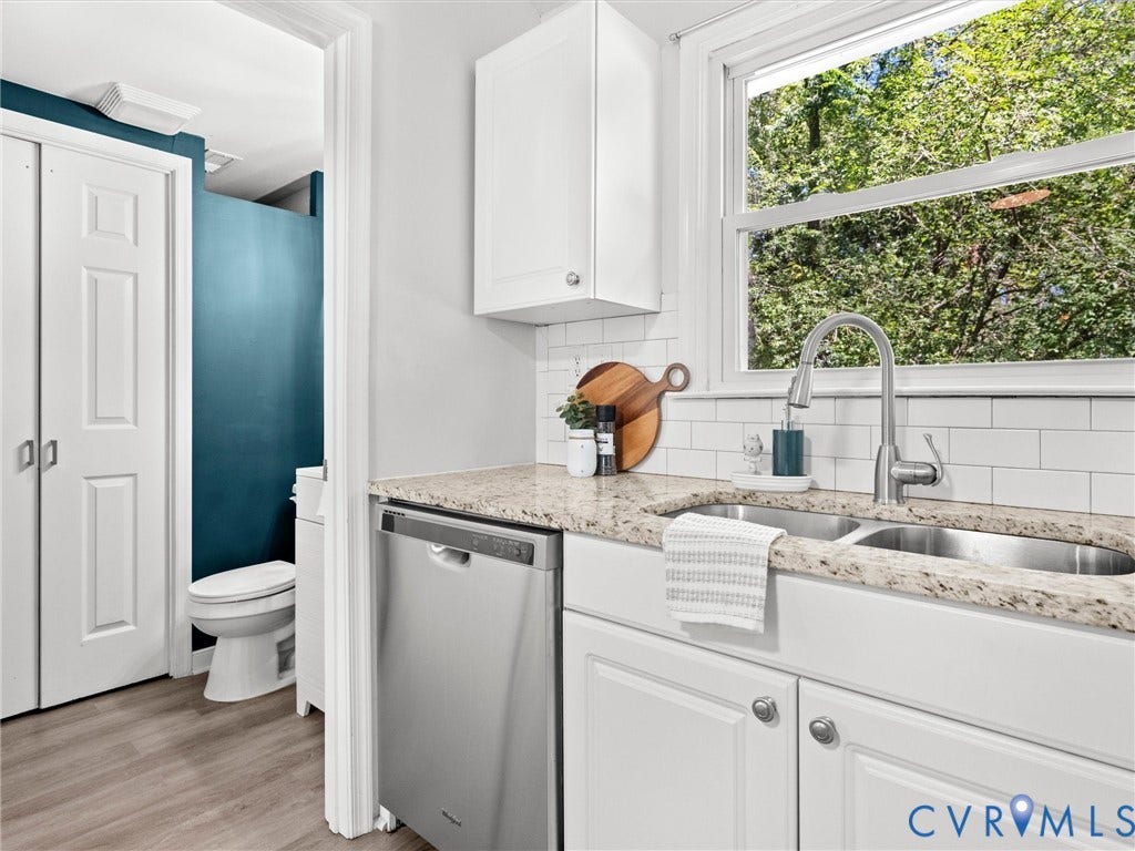 5112 Bethlehem Road, Libbie Mill Area, Richmond, VA 23230 White shaker cabinetry, stainless steel dishwasher, double basin sink with gooseneck faucet, light granite-style countertop, and white subway tile backsplash