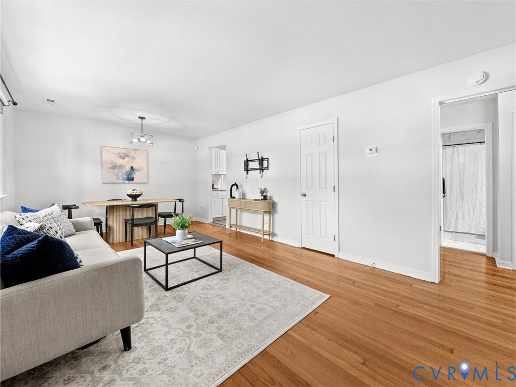 5112 Bethlehem Road, Libbie Mill Area, Richmond, VA 23230 Hardwood flooring throughout, white walls, and a modern ceiling light fixture
