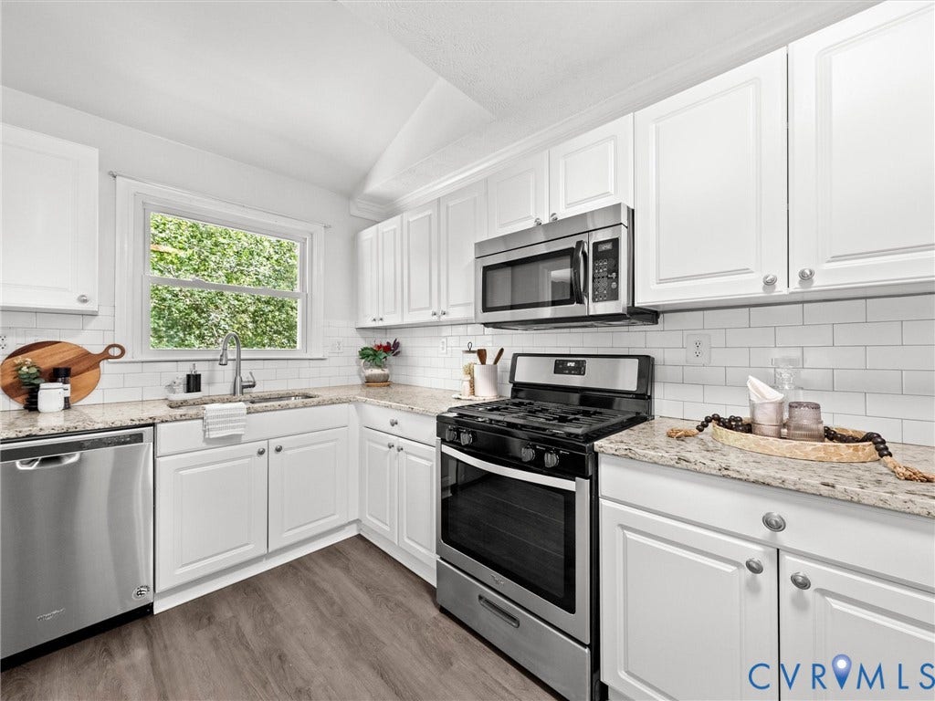 5112 Bethlehem Road, Libbie Mill Area, Richmond, VA 23230 White cabinetry, subway tile backsplash, stainless steel appliances, light-toned countertops, and wood-finish flooring