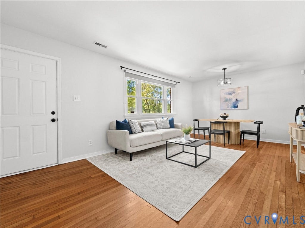 5112 Bethlehem Road, Libbie Mill Area, Richmond, VA 23230 Light-toned wood flooring, white paneled entry door, and a multi-pane window with black trim