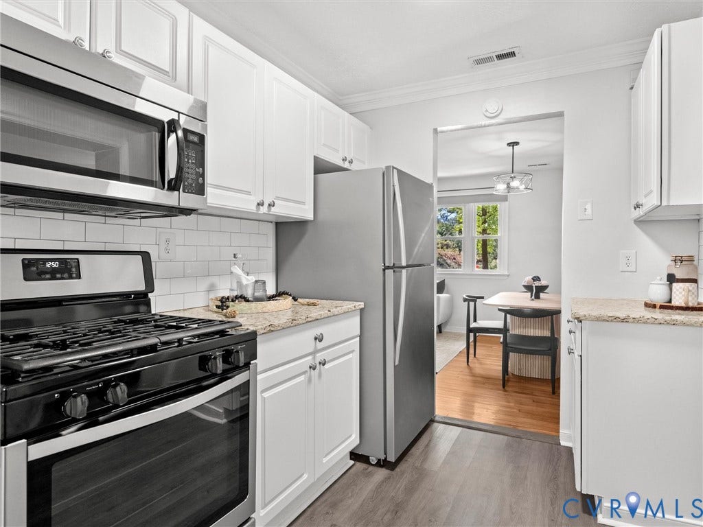 5112 Bethlehem Road, Libbie Mill Area, Richmond, VA 23230 White cabinetry, subway tile backsplash, stainless steel appliances, light-toned countertops, and wood-finish flooring