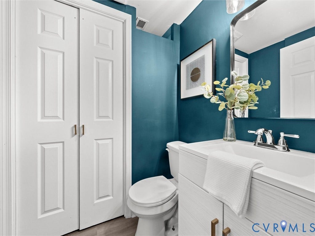 5112 Bethlehem Road, Libbie Mill Area, Richmond, VA 23230 White panel bifold doors, vanity with white integrated sink, chrome-finish faucet, and wood-finish flooring