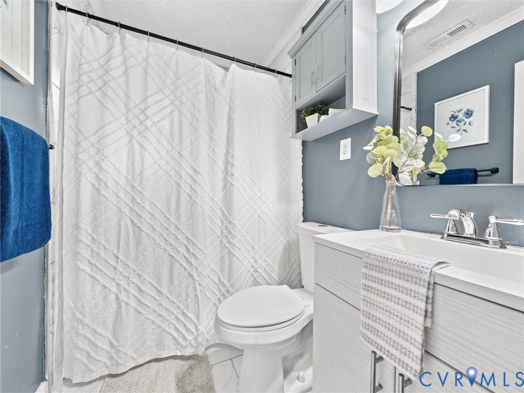 5112 Bethlehem Road, Libbie Mill Area, Richmond, VA 23230 Bathroom featuring a single vanity, integrated sink, chrome faucet, and overhead cabinetry