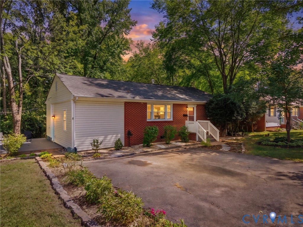 5112 Bethlehem Road, Libbie Mill Area, Richmond, VA 23230 Brick and siding exterior, front entry with white railings, attached garage, paved driveway, and mature landscaping