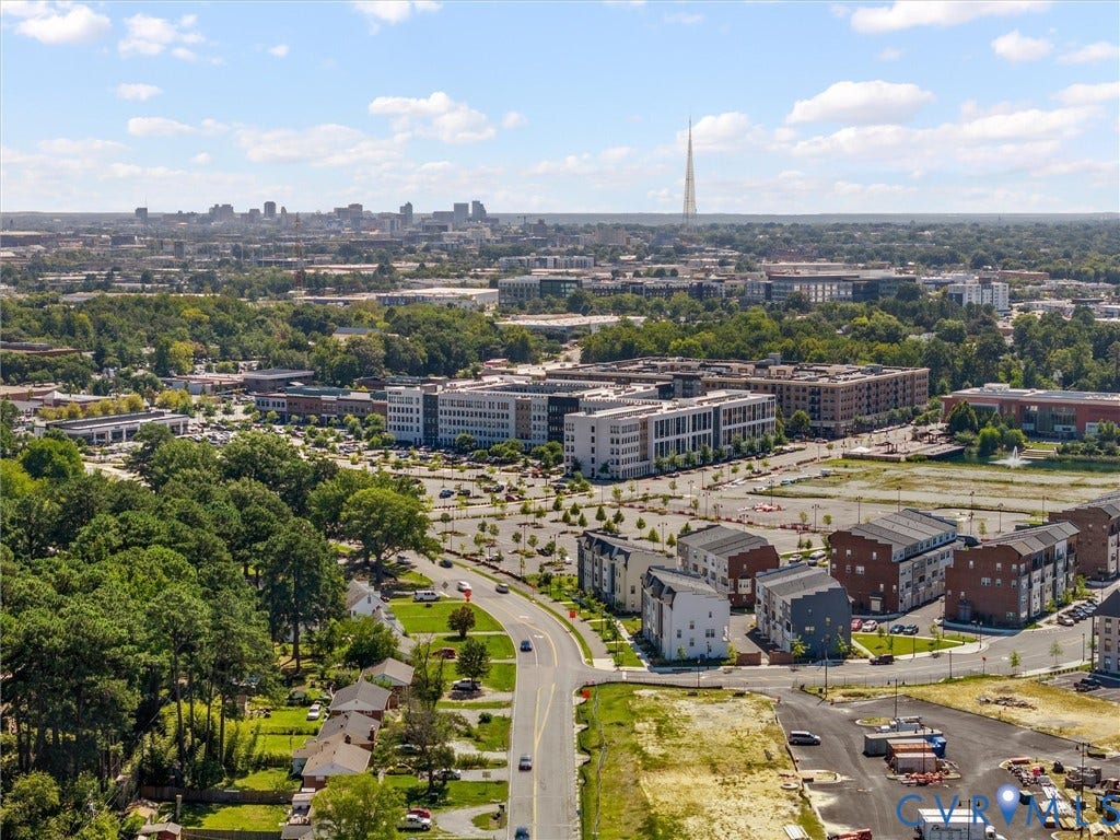 5112 Bethlehem Road, Libbie Mill Area, Richmond, VA 23230 Expansive urban landscape featuring established residential areas, modern commercial buildings, and a distant city skyline