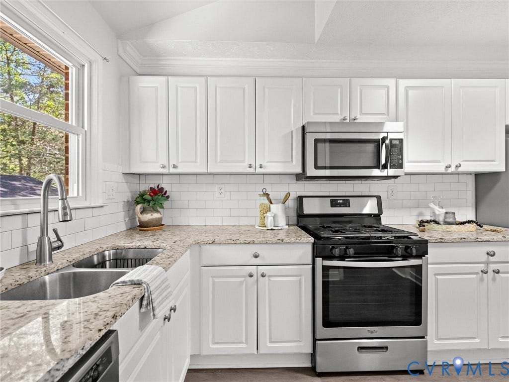 5112 Bethlehem Road, Libbie Mill Area, Richmond, VA 23230 White shaker-style cabinetry, stainless steel appliances, dual basin sink, subway tile backsplash, and light-toned countertops