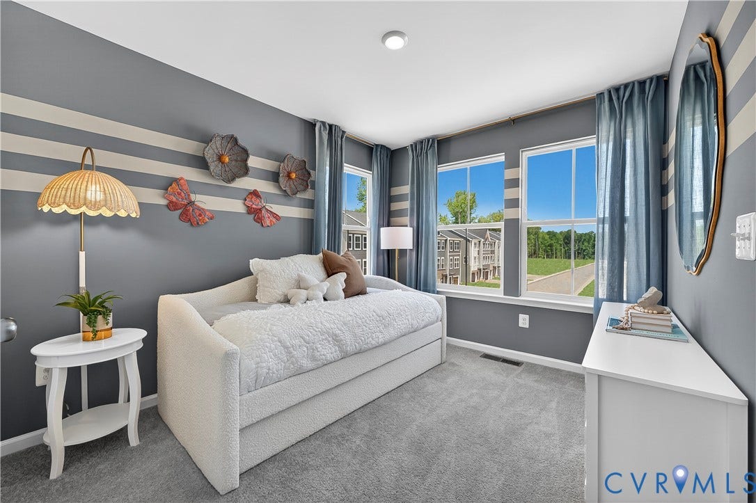 6126 Hull Street Road, Richmond, VA 23224 Neutral wall color with accent stripes, multiple windows providing natural light, recessed ceiling lighting, and carpeted flooring