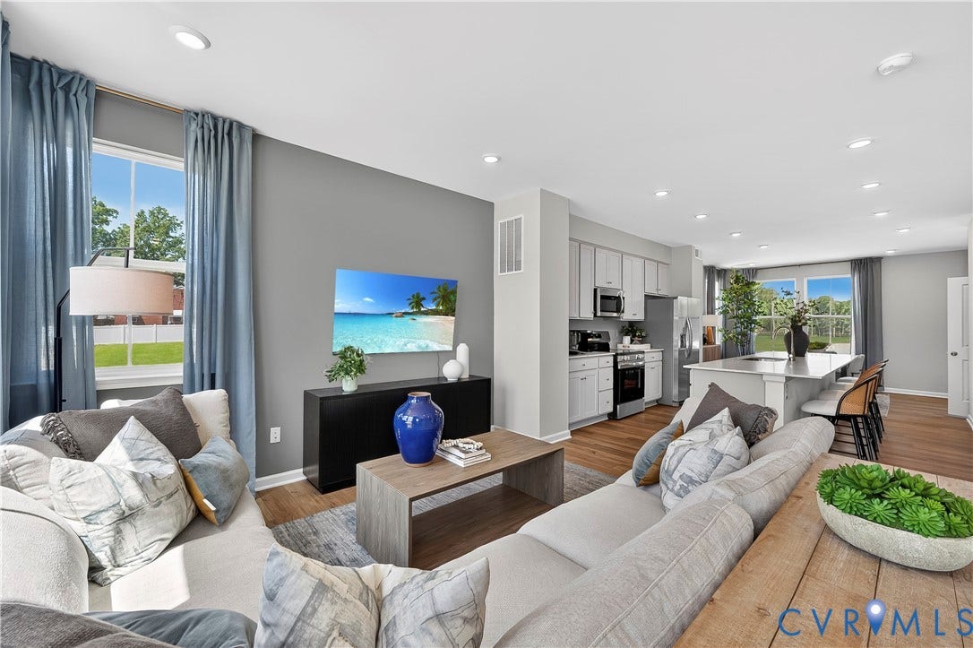 6126 Hull Street Road, Richmond, VA 23224 Open-concept living space featuring wood-finish flooring, a kitchen island with seating, recessed lighting, and stainless steel appliances