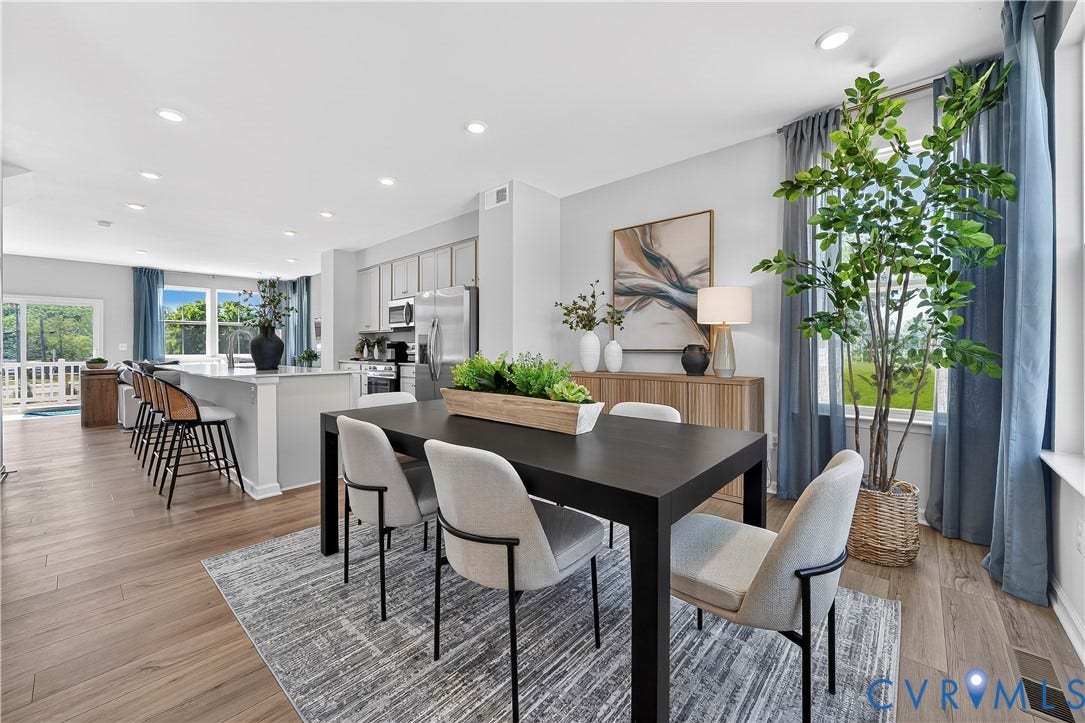 6126 Hull Street Road, Richmond, VA 23224 Open-concept living space featuring wood-finish flooring, recessed lighting, a kitchen island with seating, and sliding glass doors to an exterior balcony