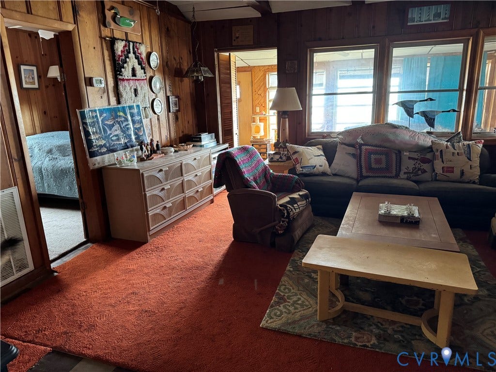 36 Beach Road, Reedville, VA 22539 Wood-paneled interior walls, wall-to-wall carpeting, and large multi-pane windows