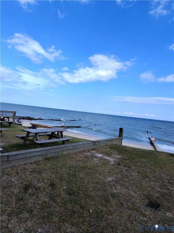 36 Beach Road, Reedville, VA 22539 Grassy embankment leading to a sandy shore with water access