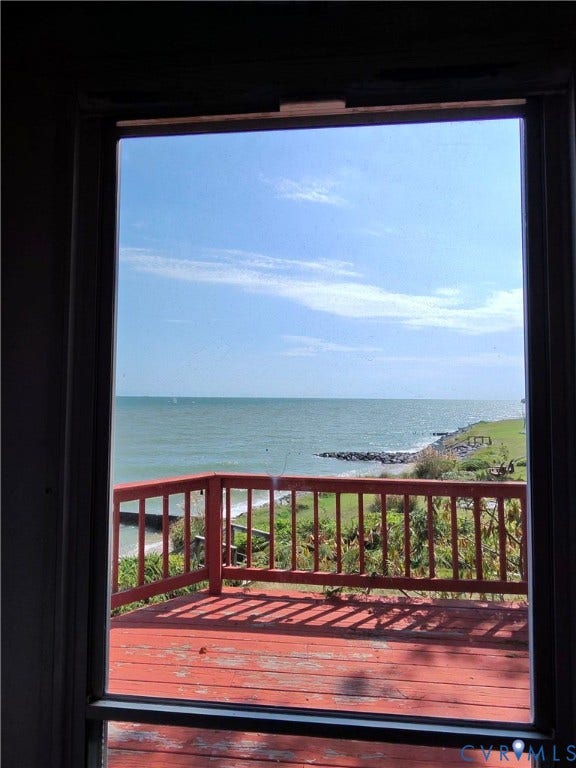 36 Beach Road, Reedville, VA 22539 Expansive outdoor deck with a wooden railing and water frontage