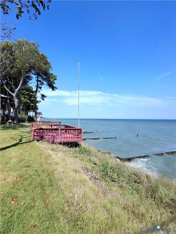 36 Beach Road, Reedville, VA 22539 Waterfront property with a red-stained wood deck, overlooking expansive water