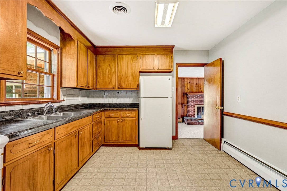 5215 Sprucewood Avenue, North Chesterfield, VA 23234 Kitchen featuring wood cabinetry, laminate countertops, a tile backsplash, and a double basin sink with a chrome faucet