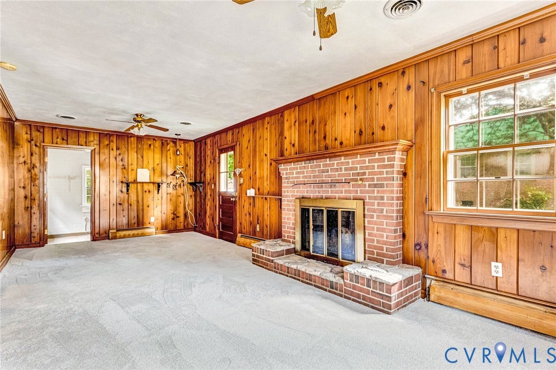 5215 Sprucewood Avenue, North Chesterfield, VA 23234 Brick fireplace with hearth, wood-paneled walls, carpet flooring, window with exterior exposure, and ceiling fan