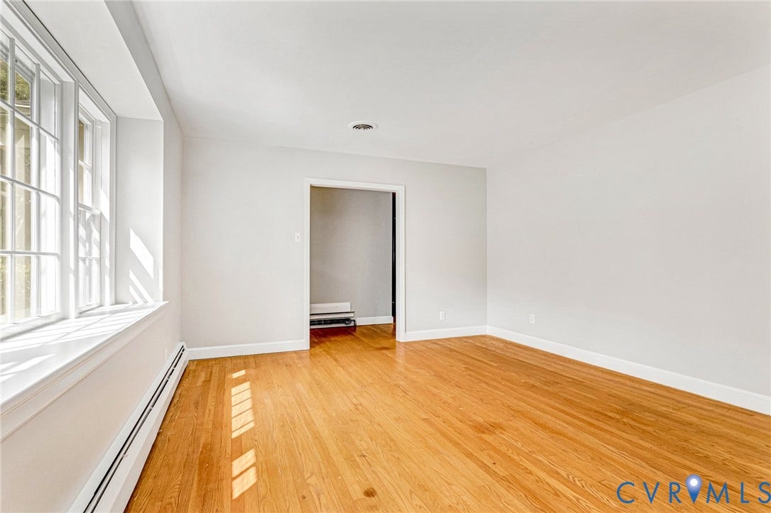 5215 Sprucewood Avenue, North Chesterfield, VA 23234 Wood-finish flooring, white painted walls, white trim, and a window with multiple panes